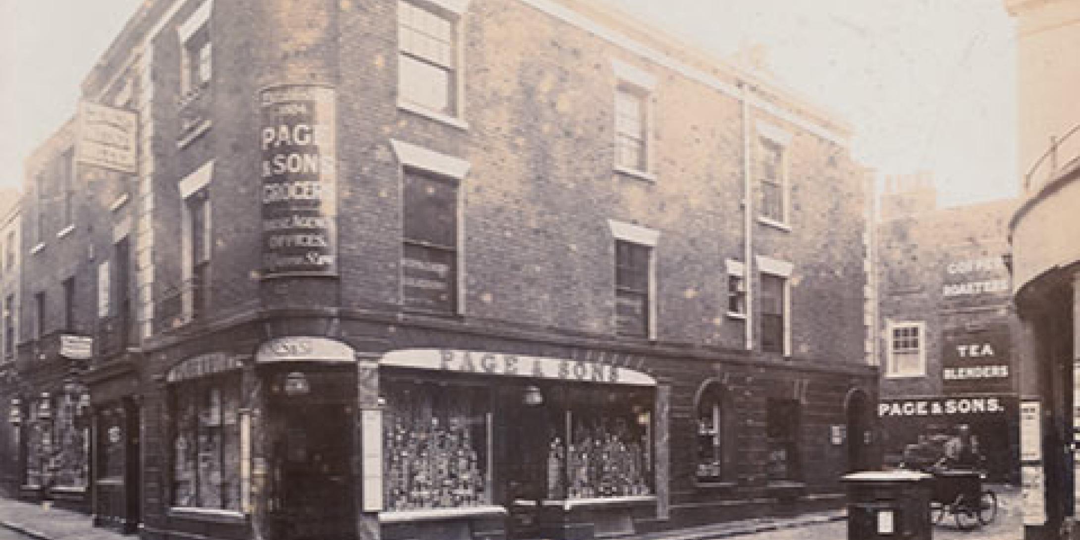 Black and white photo of Page & Sons shop front from the 1800s